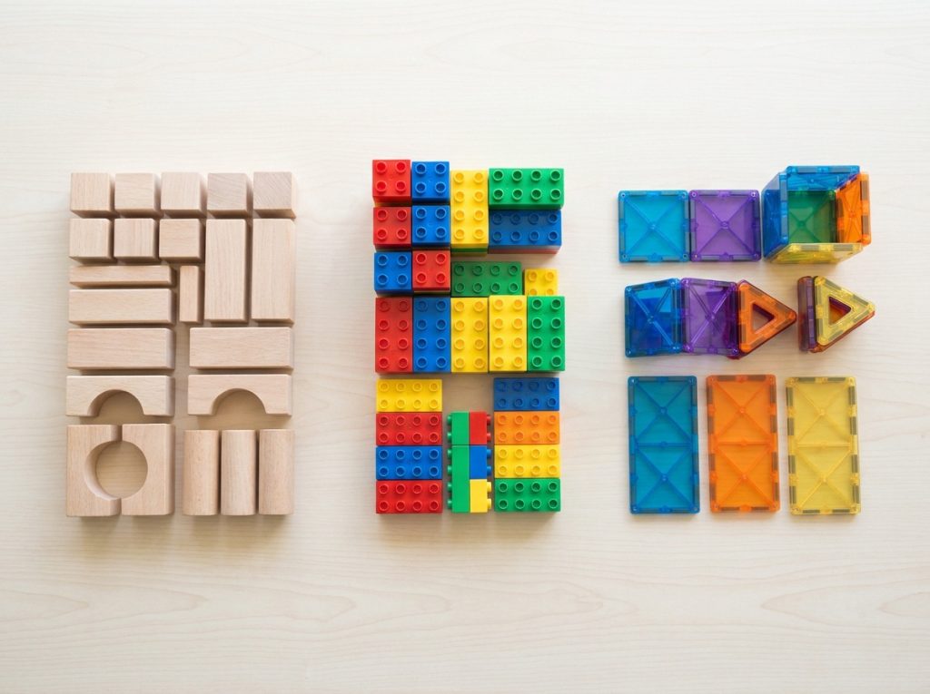 Wooden plastic and magnetic building blocks displayed on a clean table