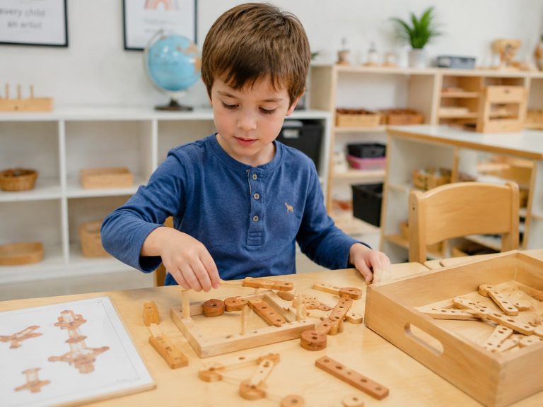 A young child engaging with colorful problem solving toys at a classroom table, demonstrating hands-on early learning.